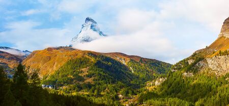 Matterhorn snow mountain peak and alpine panorama with village and ski lifts, Switzerland, Swiss Alpsの写真素材