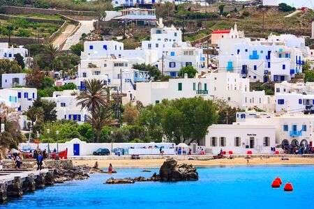 Mykonos, Greece - April 23, 2019: Famous island white houses, promenade, beach, view from the sea in Cycladesのeditorial素材