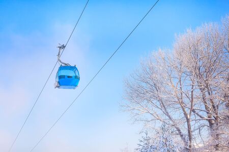 Bansko, Bulgaria winter ski resort background with blue gondola lift cabin and blue skyの写真素材