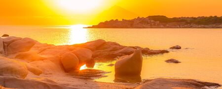 Silhouette of Holy Mount Athos, Greece at colorful sunrise or sunset, rocks and sea panorama from Karidi beach, Vourvourou, Sithoniaの写真素材