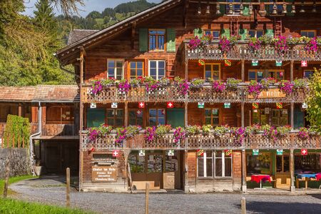 Wengen, Switzerland - October 10, 2019 : Town street view of alpine wooden house decorated with flowers in Swiss Alpsのeditorial素材