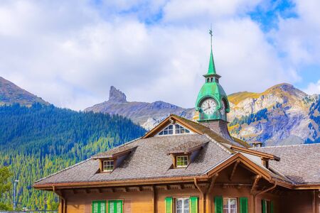 Wengen, Switzerland railway train station old wooden house with clock tower