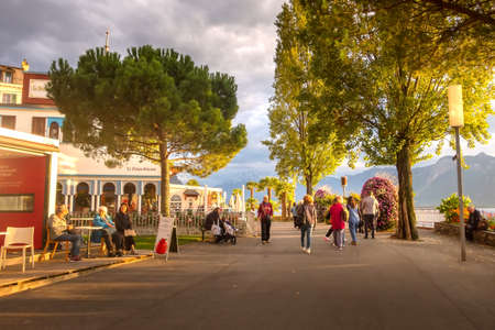 Montreux, Switzerland - October 12, 2019: Panoramic colorful sunset view of promenade street near Lake Geneva with trees and flowersのeditorial素材