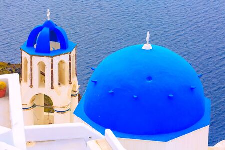 Santorini, Greece sea and iconic view of blue and white church dome in Oiaの写真素材