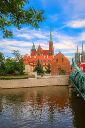 Wroclaw, Poland - June 21, 2019: Tumski island, bridge and towers of Church of the Holy Cross and the Cathedral of St. John the Baptistのeditorial素材
