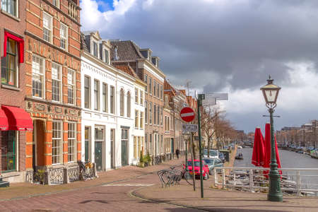 Leiden, Netherlands - April 7, 2016: Traditional houses, street view and canal in Hollandのeditorial素材