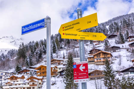 Saalbach-Hinterglemm, Austria - March 4, 2020: Directions sighpost arrows to Talschlussweg, bridge and adventure parkのeditorial素材