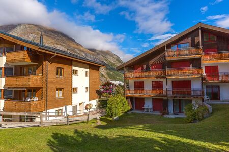 Traditional wooden houses, flowers in Zermatt, alpine village panorama, Switzerland, Swiss Alps and...