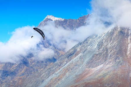 Zermatt, Switzerland - October 7, 2019: Paraglider over mountain snow peak, Swiss Alpsのeditorial素材