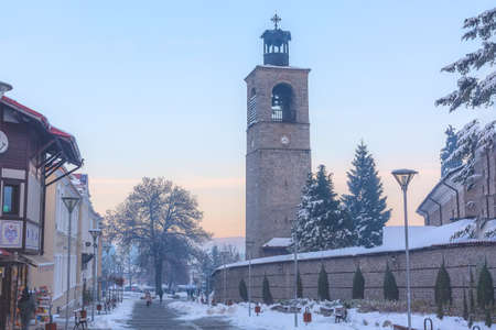 Bansko, Bulgaria - December 6, 2019: Pirin street in old town, bell tower and wall of Sveta Troitsa Churchのeditorial素材
