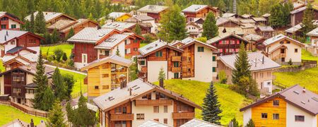 Beautiful alpine village in the pine woods, Switzerland, Swiss Alps near Zermatt, banner panoramaの写真素材