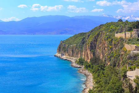 Panoramic view to the rock in Nafplio, Peloponnese, Greece and mediterranean sea, snow mountain peaksの写真素材