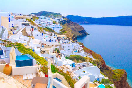 Santorini island, Greece, Oia village white houses with caldera blue sea panoramaの写真素材