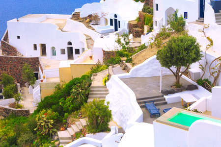 Santorini island, Greece panorama with white houses, swimming pool and blue sea
