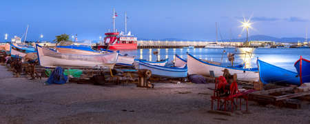Pomorie, Bulgaria beachfront sea panoramic banner with boats in the town and seaside resort on Black sea, blue hour dusk viewの写真素材