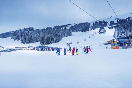 Saalbach, Austria - March 2, 2020: Cable car cabins and people skiing at ski slope of austrain winter resortのeditorial素材
