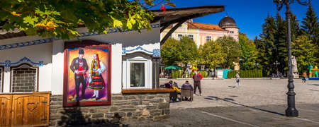 Razlog, Bulgaria - October 20, 2020: Downtown street square panoramic view with autumn trees and...