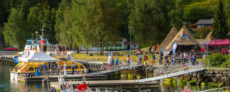 Flam, Norway - July 31, 2018: Norwegian village at Sognefjord fjord, port with boats and tourist...