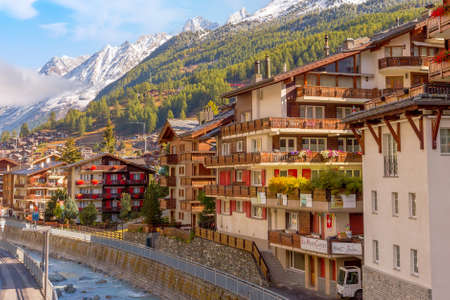 Zermatt , Switzerland - October 7, 2019: Traditional wooden houses, alpine village autumn panorama, Swiss Alps, river and snow mountains viewのeditorial素材