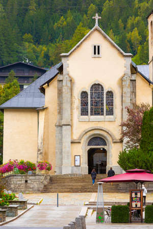 Chamonix Mont-Blanc, France - October 4, 2019: People, autumn street view with catholic church of St Michel in autumnのeditorial素材