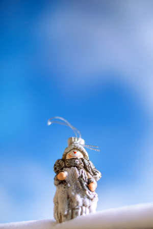 Winter Christmas card, Snowman toy in the snowの写真素材