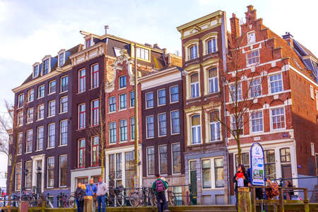 Traditional old houses near canal in Amsterdam, Netherlandsのeditorial素材