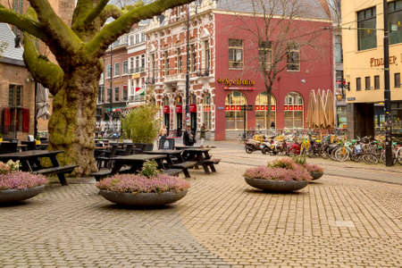 Hague, Netherlands - April 5, 2016: Row of bikes, cafe and dutch traditional houses on background in...