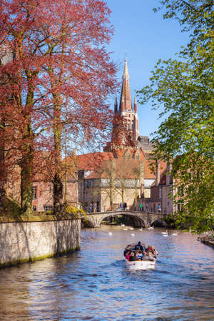 Canal and bridge view, church in Bruges, Belguimのeditorial素材