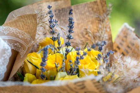 Bouquet of yellow roses and lavender. Floral shop conceptの写真素材
