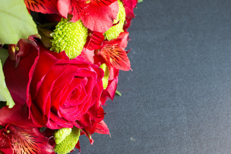 Vibrant color beautiful red rose in bouquet with water drops in the bunch close up with copyspaceの写真素材