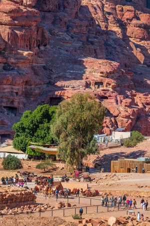 Petra, Jordan - November 3, 2022: Basin restaurant aerial view, tourists and camels at archaeological siteのeditorial素材
