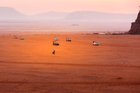 Jordan, Wadi Rum - November 1, 2022: People and jeep cars waiting for sunrise over desertのeditorial素材