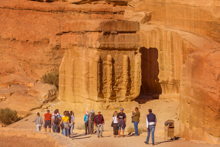 Petra, Jordan - November 3, 2022: People tourists walking along sandstone canyon, rocks formations in UNESCO World Heritage Siteのeditorial素材