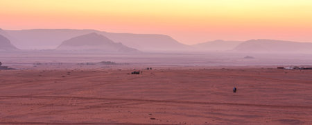 Jordan, Wadi Rum - November 1, 2022: People and jeep cars waiting for sunrise over desertのeditorial素材