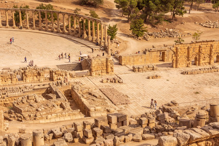 Jerash, Jordan - November 7, 2022: Square with row of Corinthian columns of Oval Forum Plaza and Cardo Maximus, high angle viewのeditorial素材