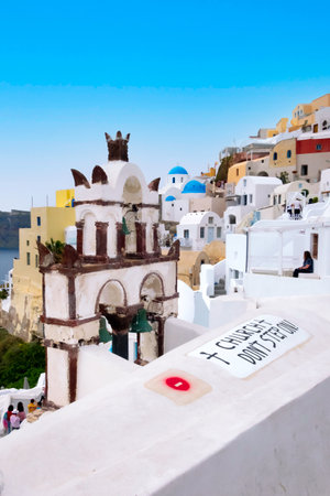 Oia, Santorini, Greece - April 25, 2019: Famous village in cyclades island with colorful houses, church domes and bell-towerのeditorial素材