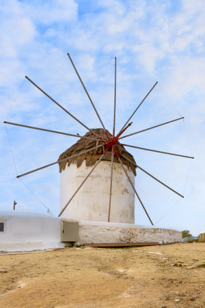 Greek iconic windmill and town panorama in Mykonos, Greece, famous Cyclades island