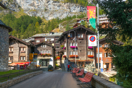 Zermatt, Switzerland - October 7, 2019: Town street view in famous swiss ski resort, colorful traditional houses, mountains and peopleのeditorial素材