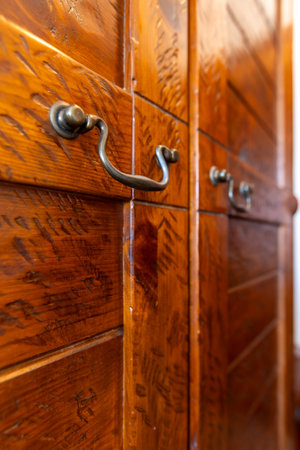 Iron vintage handle on brown antique furniture, interior of the house room, close-upの写真素材