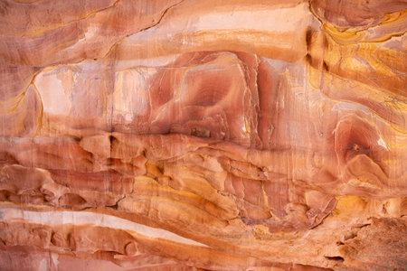Multi-colored sandstone rock and mineral layers in ancient tombs of Petra, Jordan. Pattern,...