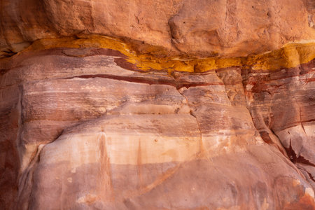 Multi-colored sandstone rock and mineral layers in ancient tombs of Petra, Jordan. Pattern,...