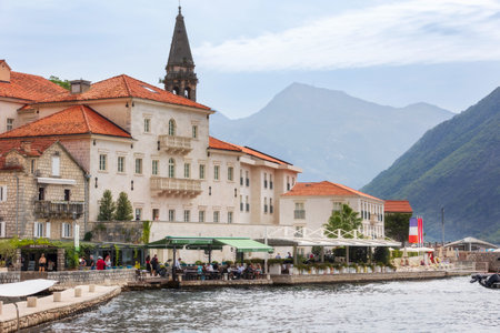 Perast, Montenegro - September 21, 2023: City view, street, houses and church tower, tourists and boatsのeditorial素材