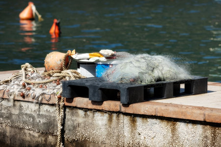 Fishing nets and ropes on the pier, sea view, close-upの写真素材