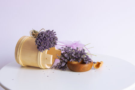 Bouquets of lavender flowers and wooden decor and organza sachet bags still-life on white table background, provence styleの写真素材