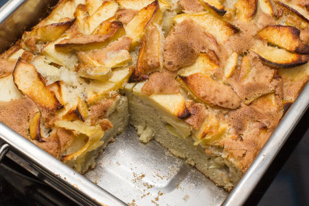 Apple cake in the rectangular steel oven-tray pan from the oven