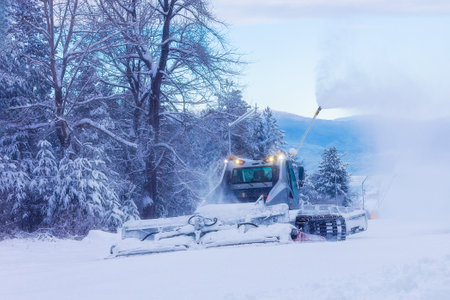 Snow groomer snowcat ratrack machine preparing ski slope for alpine skiing, winter resort Bansko, Bulgariaの写真素材