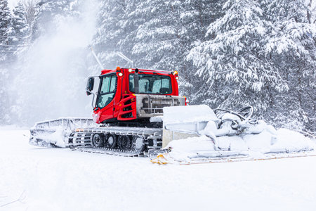 Bansko, Bulgaria ski resort, snow groomer snowcat ratrack machine preparing ski slope for alpine...