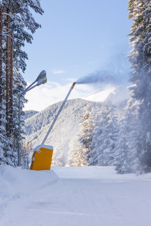 Bansko, Bulgaria winter ski resort panorama with forest pine trees, ski road and snow cannonの写真素材