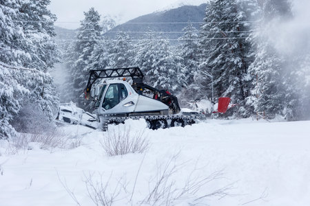 Bansko, Bulgaria - January 21, 2024: Snow groomer snowcat ratrack machine preparing ski slope for alpine skiing, winter resortのeditorial素材