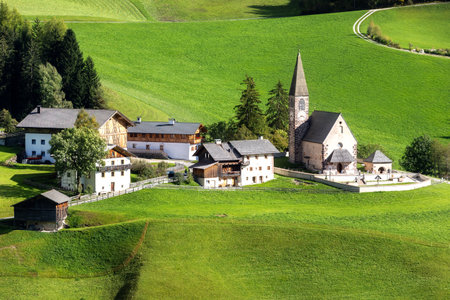 Dolomites, Italy. Aerial panoramic view of St. Magdalena or Santa Maddalena church and green alpine meadowsの写真素材